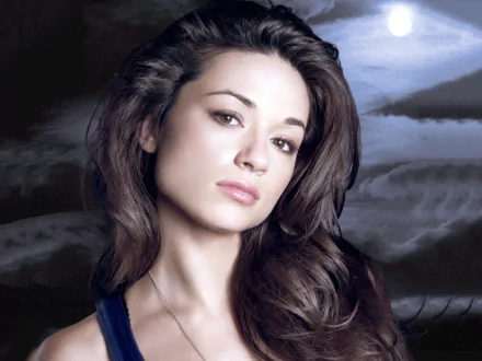 A high-definition desktop wallpaper featuring Crystal Reed, showcasing her striking features against a backdrop of serene landscapes.