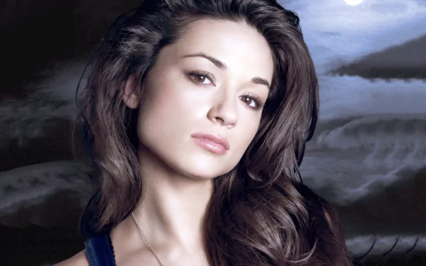A high-definition desktop wallpaper featuring Crystal Reed, showcasing her striking features against a backdrop of serene landscapes.