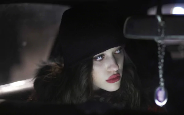 HD PC desktop wallpaper featuring a close-up portrait of celebrity Kat Dennings with a dark, moody background.