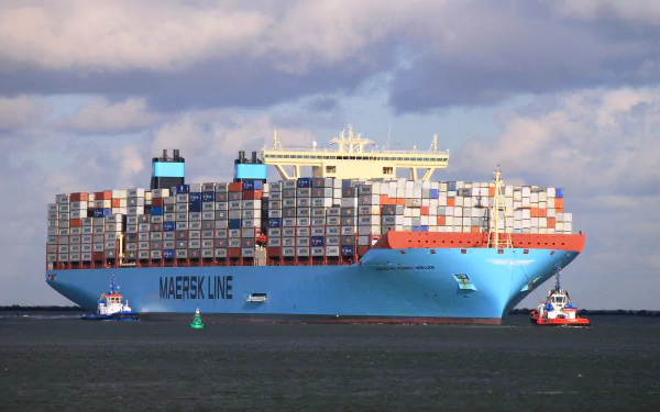 A large container ship, adorned with colorful cargo containers, is being assisted by tugboats against a backdrop of blue skies, creating a striking HD desktop wallpaper and background.