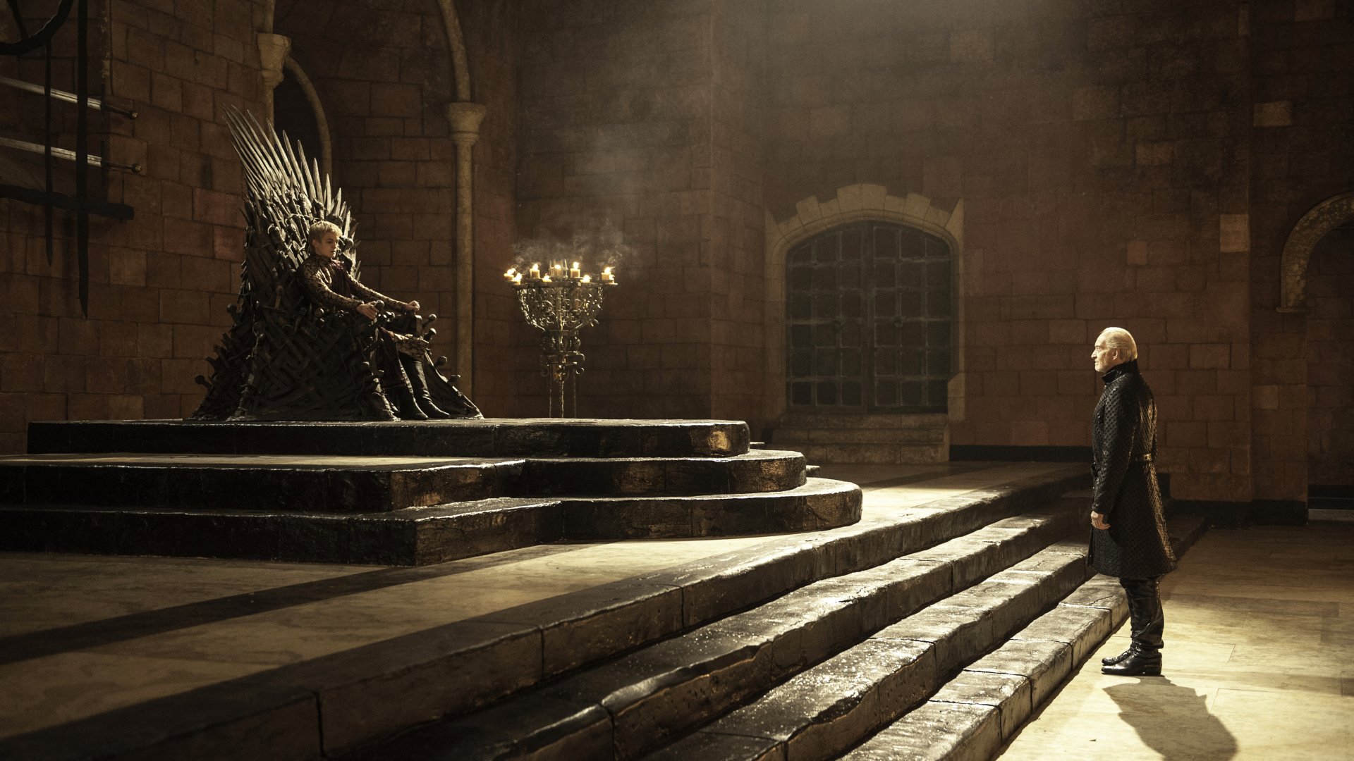Tywin Lannister and Joffrey Baratheon from Game of Thrones face each other in a dimly lit throne room, captured in a 4K Ultra HD desktop wallpaper.