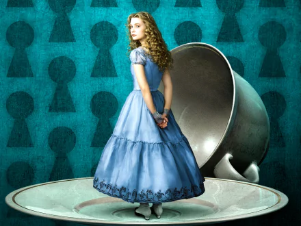 HD desktop wallpaper featuring Alice in a blue dress from the 2010 movie Alice in Wonderland, standing beside a large silver teacup against a keyhole-patterned background.