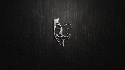 A sleek HD desktop wallpaper featuring a metallic anonymous mask against a dark, textured background, embodying the fusion of technology and anonymity.