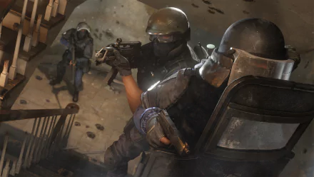 HD desktop wallpaper featuring intense action from Tom Clancy's Rainbow Six: Siege, showcasing heavily armed operators in tactical gear navigating a stairwell during a high-stakes mission.