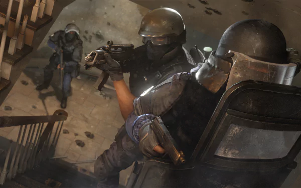 HD desktop wallpaper featuring intense action from Tom Clancy's Rainbow Six: Siege, showcasing heavily armed operators in tactical gear navigating a stairwell during a high-stakes mission.