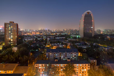 Beijing skyline at night, showcasing man-made structures with vibrant lights against a clear sky. A stunning 4K Ultra HD wallpaper capturing the city's urban beauty.
