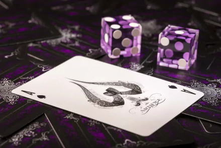 A high-definition desktop wallpaper featuring a close-up of an Ace of Spades card with purple dice on a background of patterned playing cards, evoking a casino atmosphere.