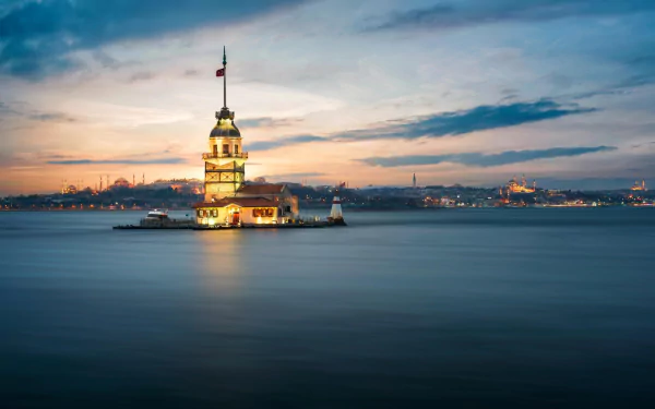 A stunning view of the Maiden's Tower in Istanbul during sunset, surrounded by calm waters and a colorful sky, serving as an HD desktop wallpaper and background.