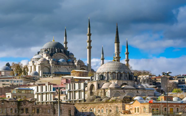 4K Ultra HD image of the Süleymaniye Mosque showcasing its majestic domes and minarets under a partly cloudy sky, capturing the essence of religious architecture.