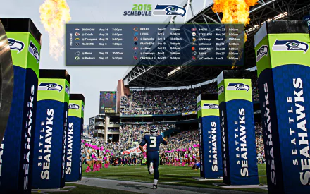 HD desktop wallpaper featuring the Seattle Seahawks 2015 schedule, capturing a player running onto the field amidst a vibrant stadium atmosphere.