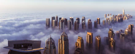Panoramic view of Sheikh Zayed Avenue in Dubai, United Arab Emirates, shrouded in morning fog. Tall buildings rise above a sea of clouds, creating a stunning HD desktop wallpaper and background.