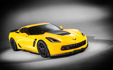 A vibrant yellow Chevrolet Corvette Z06 sports car showcased against a dark gray background, featured as a high-definition PC desktop wallpaper.