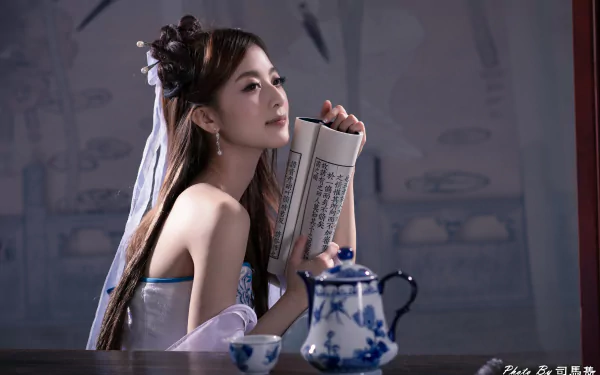 A Taiwanese Asian woman with a traditional hairpin holds a scroll near a blue and white Chinese tea set, captured in a 4K Ultra HD wallpaper by Mikako Zhang Kaijie.
