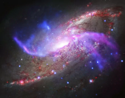 HD wallpaper of the spiral galaxy Messier 106 featuring a luminous supermassive black hole with vibrant sci-fi-inspired colors and glowing cosmic details.