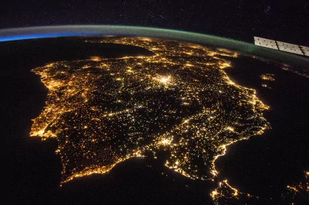 A stunning view of the Iberian Peninsula at night, showcasing the illuminated cities of Spain, Portugal, and Andorra from space, captured in 4K Ultra HD by NASA.
