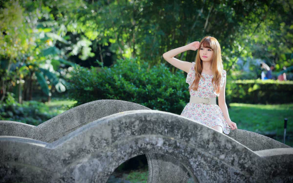 A Taiwanese woman model wearing a belted dress poses amid greenery with bokeh effects, featured in a 4K Ultra HD desktop wallpaper.