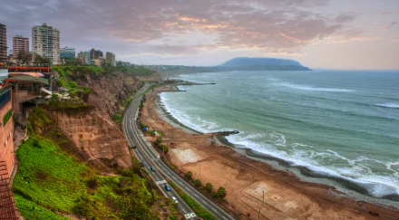 A 4K Ultra HD view of the coastal city of Lima, Peru, featuring the Santa Cruz road winding along cliffs beside the ocean.