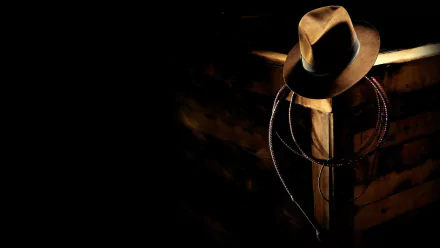HD PC desktop wallpaper featuring iconic hat and whip from the video game Indiana Jones and the Fate of Atlantis against a dark background.