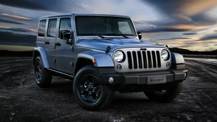 A Jeep Wrangler stands confidently against a dramatic sky, showcasing its robust 4x4 design in this stunning 4K Ultra HD desktop wallpaper.