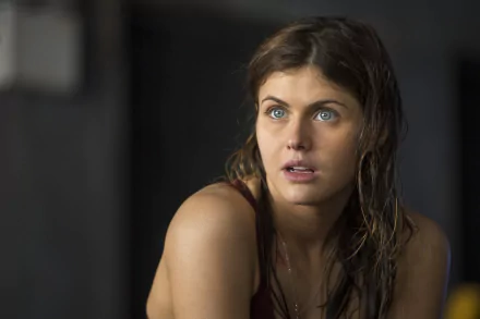 Brunette actress Alexandra Daddario gazes intently, showcasing her striking blue eyes in a scene from the movie San Andreas. This high-definition wallpaper captures her expressive features beautifully.