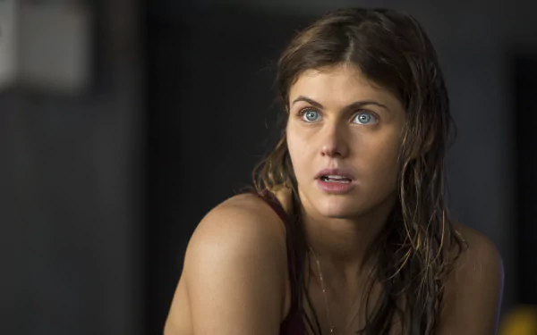 Brunette actress Alexandra Daddario gazes intently, showcasing her striking blue eyes in a scene from the movie San Andreas. This high-definition wallpaper captures her expressive features beautifully.