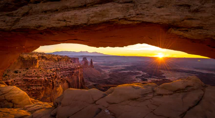 Sunrise through Mesa Arch at Canyonlands National Park, Utah — a glowing natural canyon vista and sky, 5K Ultra HD PC desktop wallpaper and background.