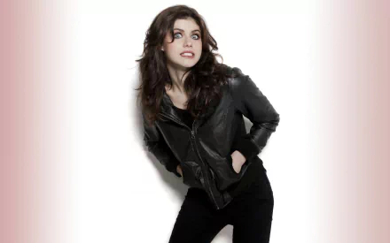HD wallpaper and background featuring celebrity Alexandra Daddario, dressed in a black leather jacket, posing against a white backdrop.