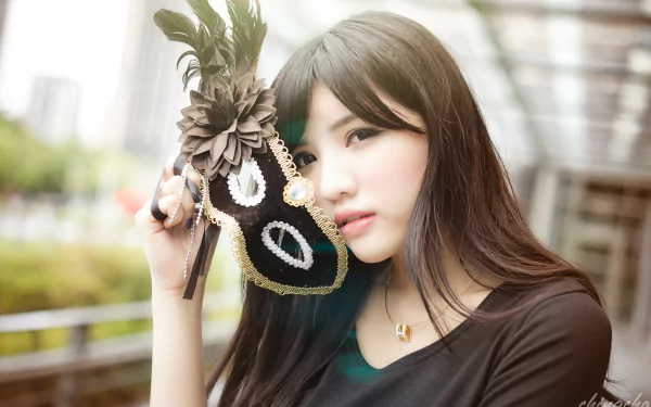 Taiwanese Asian model Ka Ka poses with a decorative black mask adorned with feathers, captured in vibrant 4K Ultra HD as a PC desktop wallpaper background.