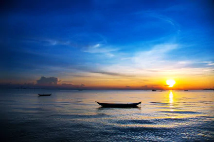 4K Ultra HD landscape of a serene ocean at sunset with a small boat floating on calm waters under a vibrant sky, captured in stunning nature photography.