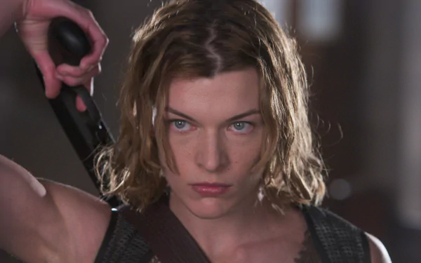 Milla Jovovich as Alice, poised for action in Resident Evil: Apocalypse. A striking HD wallpaper capturing her fierce determination in the iconic role.