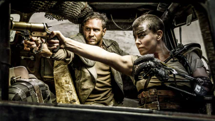 Max Rockatansky and Imperator Furiosa brandish weapons in a tense moment from Mad Max: Fury Road, showcasing the intense action of the film in a striking HD desktop wallpaper.