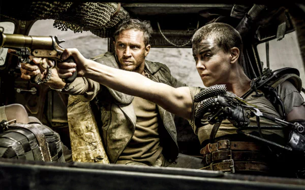 Max Rockatansky and Imperator Furiosa brandish weapons in a tense moment from Mad Max: Fury Road, showcasing the intense action of the film in a striking HD desktop wallpaper.