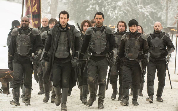 Clive Owen leads a group of armored warriors in a snowy scene from the movie Last Knights, featured as a 4K Ultra HD PC desktop wallpaper and background.