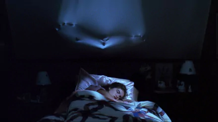 HD PC desktop wallpaper from A Nightmare on Elm Street (1984): woman sleeps as a clawed hand bulges through the ceiling above her.