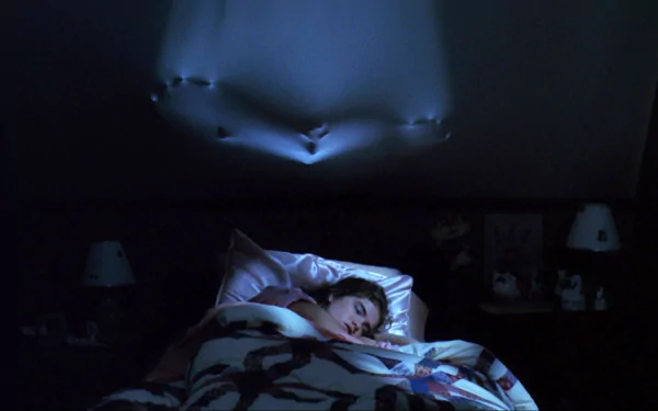 HD PC desktop wallpaper from A Nightmare on Elm Street (1984): woman sleeps as a clawed hand bulges through the ceiling above her.