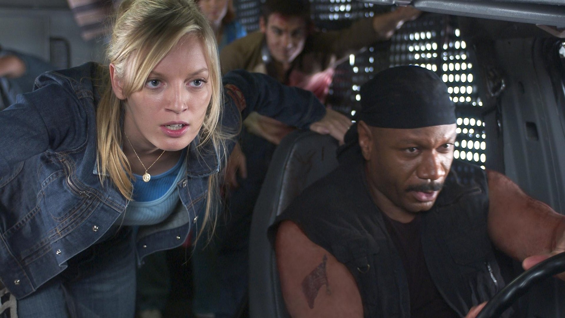 HD PC desktop wallpaper featuring a tense scene from the 2004 movie Dawn of the Dead, showing characters inside a vehicle preparing for action.