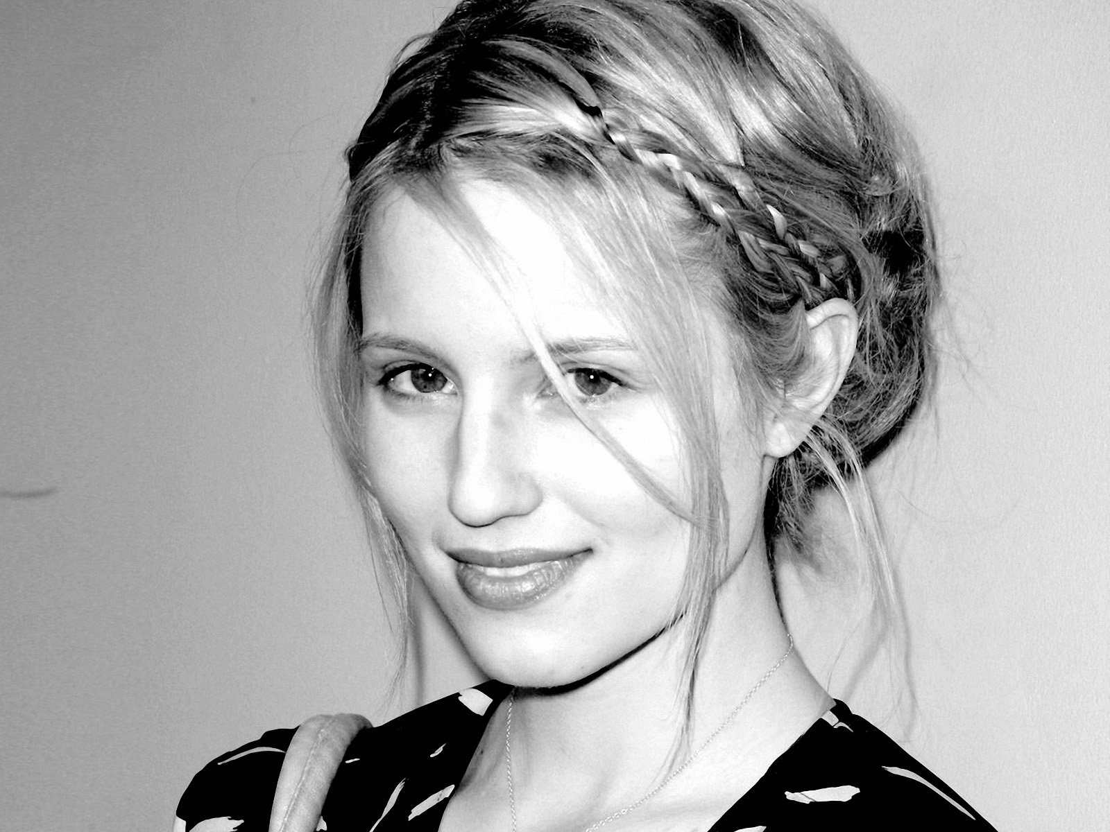Black-and-white HD desktop wallpaper featuring celebrity Dianna Agron with braided hair and a soft smile against a plain background.