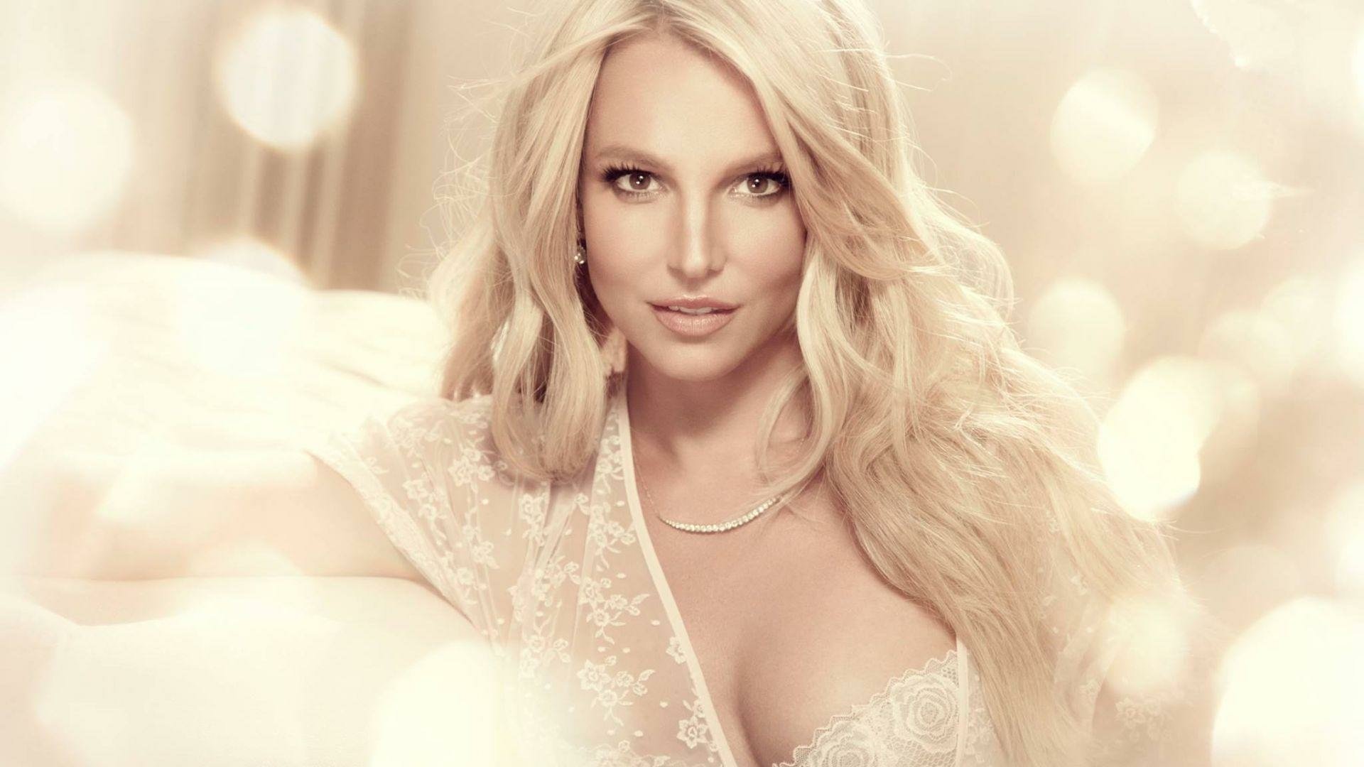 HD PC desktop wallpaper featuring Britney Spears with a soft, glowing background, highlighting her iconic presence in music.