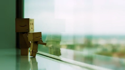 Danbo cardboard figures by a window, one small holding the other's hand; reflection and a blurred cityscape. Misc danbo HD PC desktop wallpaper background.