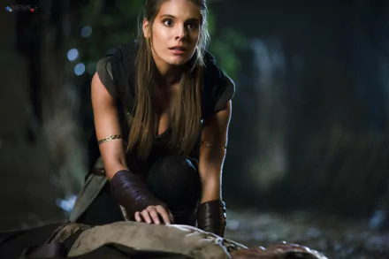 Caitlin Stasey portrays a determined character in a dramatic scene from the movie I, Frankenstein, set against a shadowy, atmospheric backdrop.