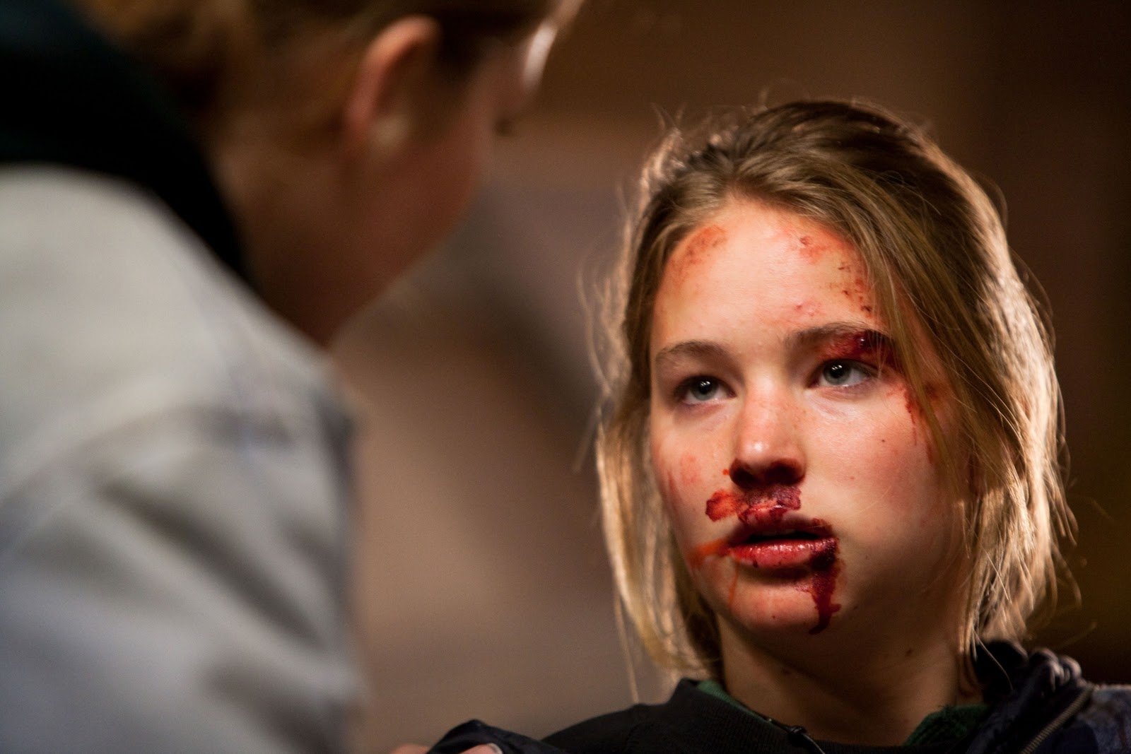 HD PC desktop wallpaper — still from the movie Winter's Bone: young woman in close-up with a bruised, bloodied face and an intense, determined expression.