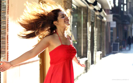 HD desktop wallpaper featuring Raashi Khanna, a woman in a flowing red dress, smiling with arms outstretched on a sunny street.