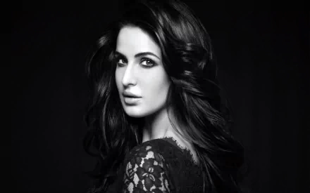 A striking black and white HD wallpaper featuring celebrity Katrina Kaif, showcasing her elegant profile and enchanting gaze against a dark background.