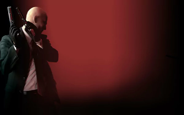 HD PC desktop wallpaper from the video game Hitman: Absolution — Agent 47 in a suit, bald, holding a silenced pistol at left against a red-to-black gradient background.