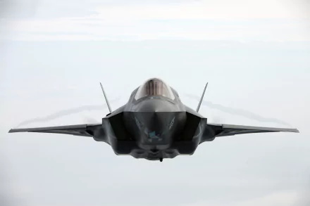 Front view of Lockheed Martin F-35 Lightning II military jet flying above clouds — HD PC desktop wallpaper/background.
