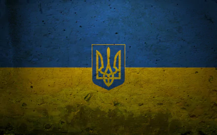 HD desktop wallpaper featuring the flag of Ukraine, showcasing its blue and yellow colors with a prominent trident emblem set against a textured background.