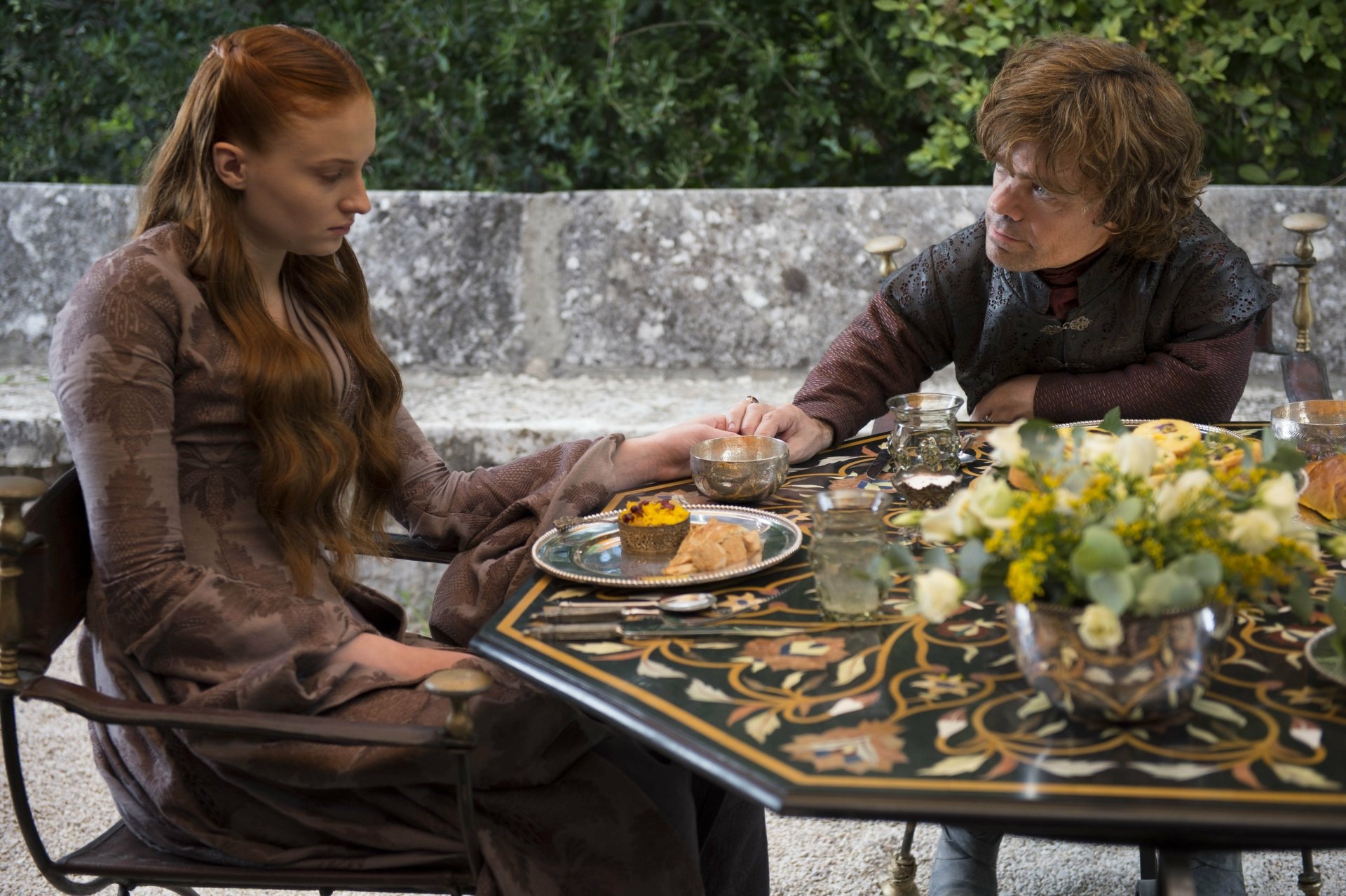 Sansa Stark (Sophie Turner) and Tyrion Lannister (Peter Dinklage) share a moment at an ornate table in this 4K Ultra HD Game of Thrones desktop wallpaper.