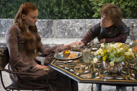 Sansa Stark (Sophie Turner) and Tyrion Lannister (Peter Dinklage) share a moment at an ornate table in this 4K Ultra HD Game of Thrones desktop wallpaper.