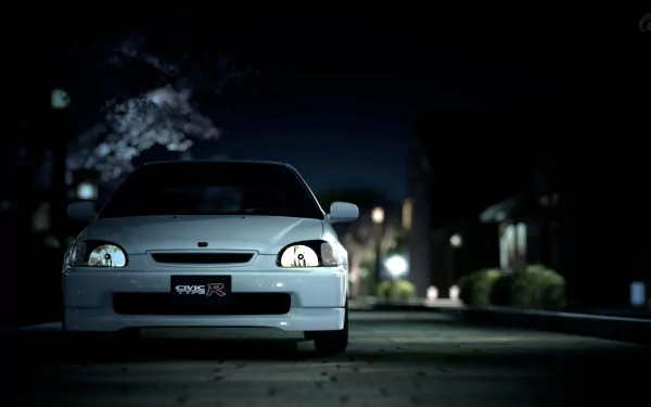 A sleek Honda Civic parked at night, illuminated by soft streetlights, creating a striking HD desktop wallpaper and background.
