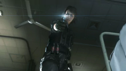 HD PC wallpaper from Metal Gear Solid V: The Phantom Pain — low-angle shot of a black-clad operative aiming a pistol at the viewer in a dim industrial room.